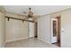 A simple bedroom with two doors, a ceiling fan, and neutral color on the walls at 12502 Tocci Ln, Riverview, FL 33579