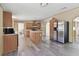 Lovely kitchen featuring a central island, stainless steel appliances and new laminate flooring at 12502 Tocci Ln, Riverview, FL 33579