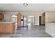 Spacious kitchen with wood cabinets, stainless steel fridge, and modern laminate flooring throughout at 12502 Tocci Ln, Riverview, FL 33579