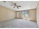 Inviting living room with neutral walls, ceiling fan and plush carpet for a cozy atmosphere at 12502 Tocci Ln, Riverview, FL 33579