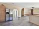 Open-concept living space featuring stainless fridge, light walls, laminate flooring, and archways at 12502 Tocci Ln, Riverview, FL 33579