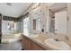 The main bathroom features a double sink vanity and a soaking tub with a shower at 12502 Tocci Ln, Riverview, FL 33579