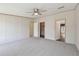 The spacious main bedroom has carpet flooring, a ceiling fan, and access to a walk-in closet at 12502 Tocci Ln, Riverview, FL 33579