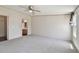 Spacious main bedroom with neutral carpet, ceiling fan, and ensuite access at 12502 Tocci Ln, Riverview, FL 33579