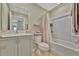 Neutral bathroom with a vanity, toilet, and shower/tub combo with curtain at 12950 Pasture Woods Pl, Lithia, FL 33547