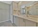 Bathroom featuring double sinks, wood look flooring, and a walk in shower behind a glass door at 12950 Pasture Woods Pl, Lithia, FL 33547