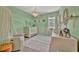 Cozy Bedroom features soft green walls, a chandelier, and decorative animal accents at 12950 Pasture Woods Pl, Lithia, FL 33547