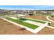 Aerial view of neighborhood bocce ball court with shaded seating area at 12950 Pasture Woods Pl, Lithia, FL 33547