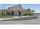 Charming stone clubhouse featuring a welcoming entrance, bike rack, and beautifully landscaped surroundings at 12950 Pasture Woods Pl, Lithia, FL 33547