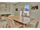 Contemporary dining area featuring a wooden table with seating for six and backyard view at 12950 Pasture Woods Pl, Lithia, FL 33547