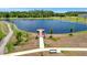 Picturesque lake featuring a wooden dock and a pathway for leisurely strolls at 12950 Pasture Woods Pl, Lithia, FL 33547