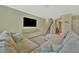 Comfortable living room with sectional, mounted TV, and staircase leading to the upper level at 12950 Pasture Woods Pl, Lithia, FL 33547