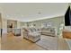 Spacious living room featuring modern furnishings, an open layout, and natural light at 12950 Pasture Woods Pl, Lithia, FL 33547