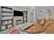 Comfortable loft area with a fireplace, bookshelves, and a couch perfect for relaxation at 12950 Pasture Woods Pl, Lithia, FL 33547