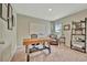 Bright home office with a large desk, whiteboard, and comfortable seating area at 12950 Pasture Woods Pl, Lithia, FL 33547