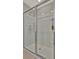 Modern shower with sliding glass doors and built-in shelving for storage and convenience at 12950 Pasture Woods Pl, Lithia, FL 33547