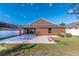A spacious backyard features a concrete patio, lush green grass, and a well-maintained lawn, perfect for outdoor activities at 13653 Artesa Bell Dr, Riverview, FL 33579