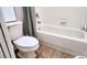 Bathroom featuring a toilet, bathtub, and shower with tile surround at 13653 Artesa Bell Dr, Riverview, FL 33579