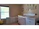 Bright Bedroom with white crib, dresser, and natural light at 13653 Artesa Bell Dr, Riverview, FL 33579