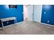 Bedroom with blue walls and a view of an attached bathroom at 13653 Artesa Bell Dr, Riverview, FL 33579