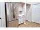 Kitchen area features a stainless steel refrigerator and sleek cabinets with white countertops at 13653 Artesa Bell Dr, Riverview, FL 33579