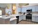 Modern kitchen featuring stainless steel appliances and light blue cabinetry at 13653 Artesa Bell Dr, Riverview, FL 33579