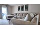Living room showcases a neutral sectional sofa, glass table, and natural lighting at 13653 Artesa Bell Dr, Riverview, FL 33579