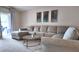 Living room with neutral sectional sofa, glass table, and access to the outdoor patio at 13653 Artesa Bell Dr, Riverview, FL 33579