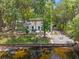 Aerial view showcasing the property's backyard, firepit, canal access, and lush landscaping at 1407 Jean St, Lutz, FL 33548