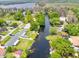 Aerial view of a canal-front neighborhood, showing houses with boat docks and lush greenery at 1407 Jean St, Lutz, FL 33548