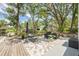 Spacious backyard features a patio with comfortable seating and stunning lake views at 1407 Jean St, Lutz, FL 33548