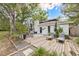 Beautiful backyard patio with modern furniture, lush landscaping, and stylish outdoor décor at 1407 Jean St, Lutz, FL 33548