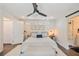 This bedroom features a modern ceiling fan, bright natural light and is decorated with neutral colors at 1407 Jean St, Lutz, FL 33548
