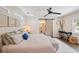 Bright bedroom with a white rug, a ceiling fan, an ensuite bathroom and a sliding barn door at 1407 Jean St, Lutz, FL 33548