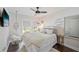 Comfortable bedroom with neutral tones, a cozy bed, a macrame swing chair, and natural light at 1407 Jean St, Lutz, FL 33548