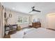 Bright, airy bedroom features a ceiling fan, wood floors, a desk, and lots of natural light at 1407 Jean St, Lutz, FL 33548