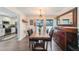 Bright dining room featuring a rustic wood table, modern chandelier, and a large mirror at 1407 Jean St, Lutz, FL 33548