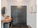 Inviting foyer featuring dark double doors, modern console table, round mirror, and stylish decor for a welcoming entrance at 1407 Jean St, Lutz, FL 33548