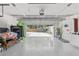 Large garage with painted floor featuring a utility sink, storage, and open door to the backyard at 1407 Jean St, Lutz, FL 33548