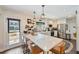 Bright kitchen with a quartz countertop island, white cabinets, stainless steel appliances, and modern pendant lighting at 1407 Jean St, Lutz, FL 33548