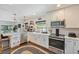 Bright kitchen with white cabinets, stainless steel appliances, subway tile backsplash and dark flooring at 1407 Jean St, Lutz, FL 33548