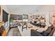 Bright living room with modern decor, foosball table, and an open floor plan leading into the kitchen at 1407 Jean St, Lutz, FL 33548