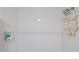 Modern shower with white subway tiles, a rain shower head, and built-in shelving for toiletries at 1407 Jean St, Lutz, FL 33548