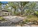 Large sand volleyball court in a well-maintained backyard with mature trees offering shade at 1407 Jean St, Lutz, FL 33548