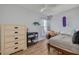 Bright bedroom features a desk area, light hardwood floors, and a ceiling fan at 1501 Wisconsin Ave, Palm Harbor, FL 34683