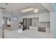 Well-lit kitchen featuring white cabinets, stainless steel appliances, and a decorative backsplash at 1501 Wisconsin Ave, Palm Harbor, FL 34683