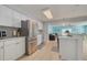 Modern kitchen with white cabinets, stainless steel appliances, and an open layout that flows into the living area at 1501 Wisconsin Ave, Palm Harbor, FL 34683