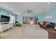 Bright living room features a ceiling fan, hardwood floors, and an open floor plan that leads to the kitchen at 1501 Wisconsin Ave, Palm Harbor, FL 34683
