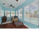 Bright sunroom with hardwood floors, lots of natural light, and views of the pool at 1501 Wisconsin Ave, Palm Harbor, FL 34683