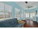 Bright sunroom with hardwood floors, lots of natural light, and views of the backyard at 1501 Wisconsin Ave, Palm Harbor, FL 34683
